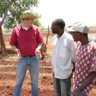 Agriculture specialist talking with officer and farmer in Zimbabwe